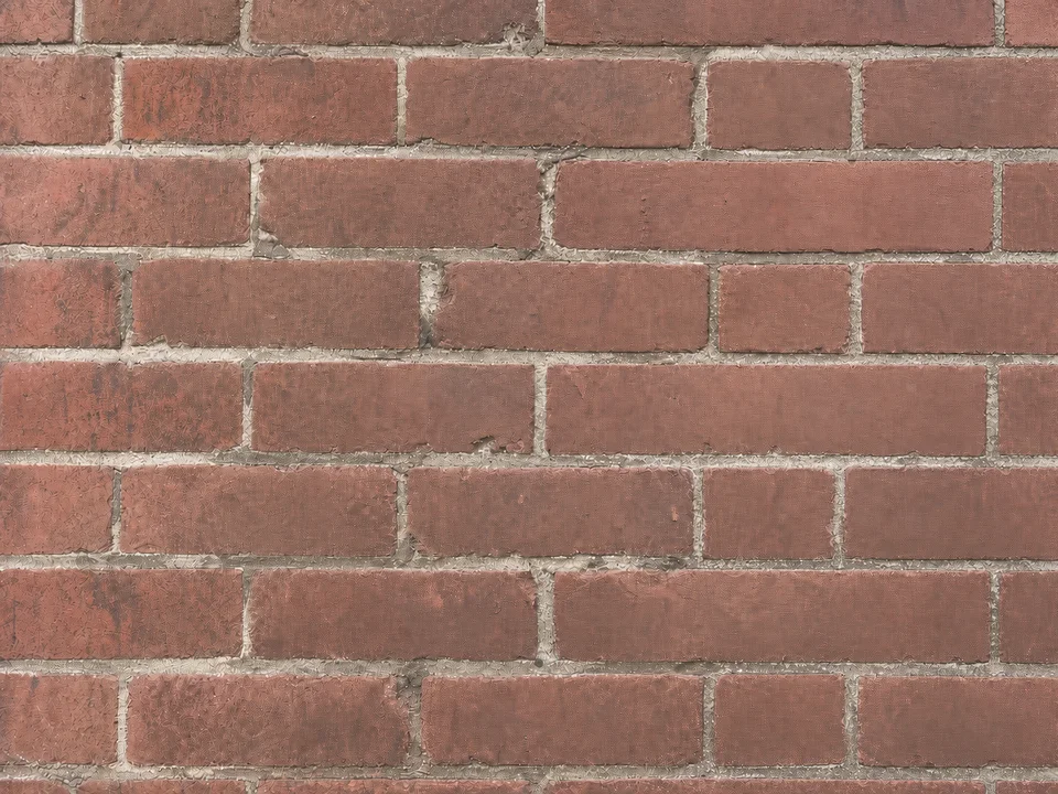 Original brick wall after soot removal with the opening repaired